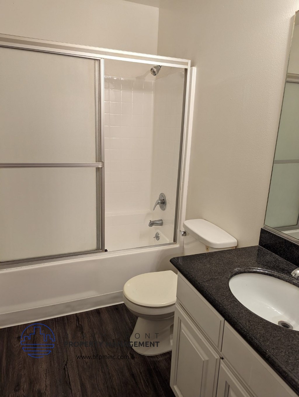 a bathroom with a shower and a toilet and a sink